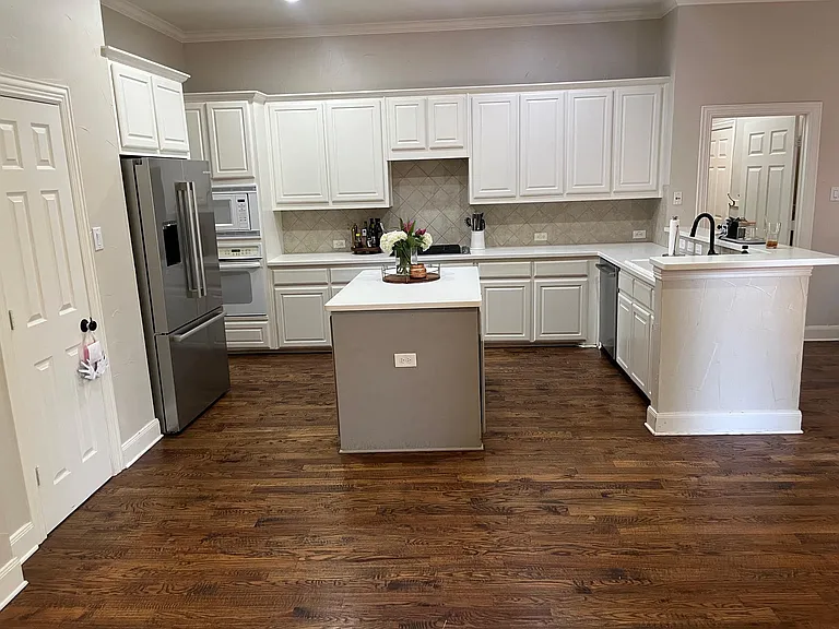 View of kitchen with island and refigerator stays with the home