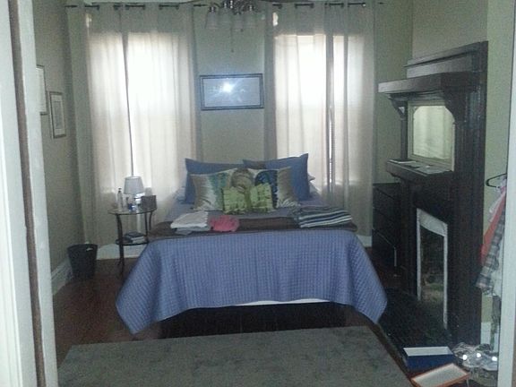 living room / front bedroom with pocket doors and separate door.