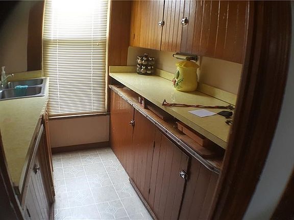 Galley kitchen with sink and counters.