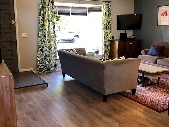 Enter through the front door into the family/living space, which walks into the dining/kitchen area.
