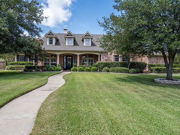 Sit on the covered front porch with a glass of iced tea and wave to your neighbors as they pass by on their daily walks!