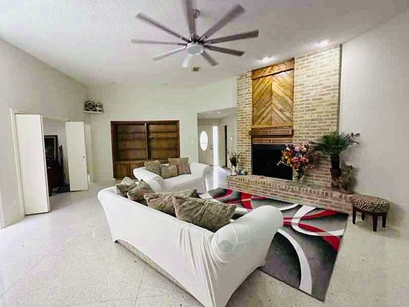 Spacious living room with fireplace and built in bookcase.