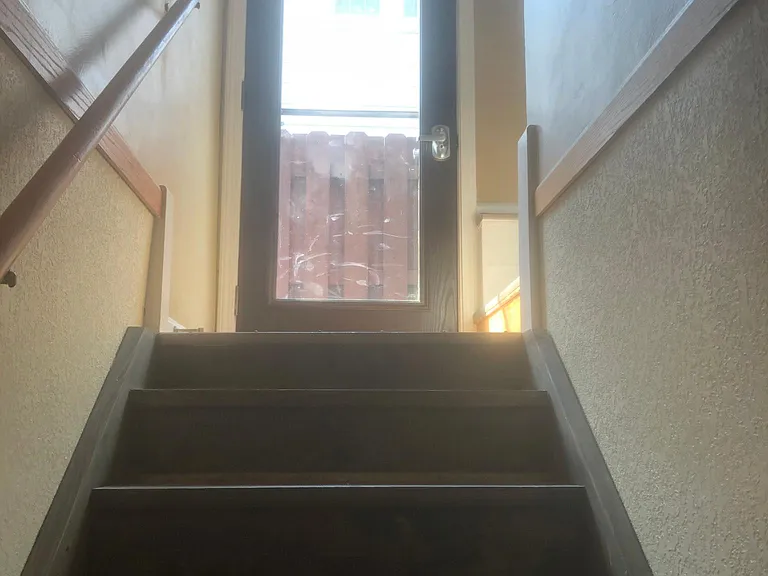 Side entry leading to kitchen and basement
