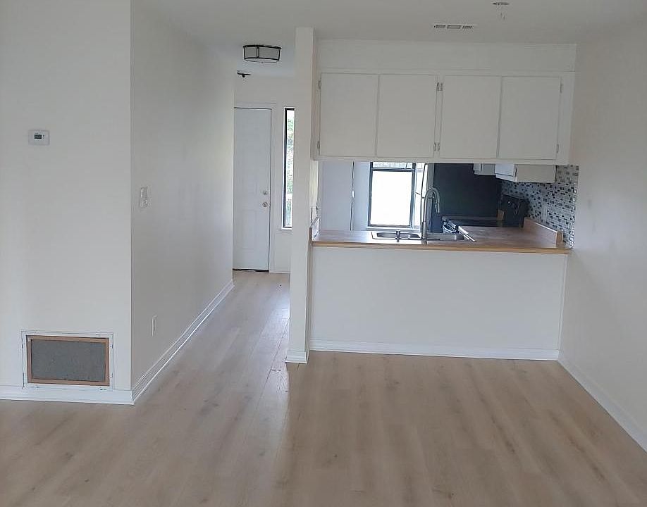 View of kitchen and front door from the living room