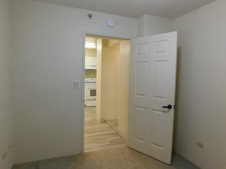 Guest bedroom with door to hall/kitchen.