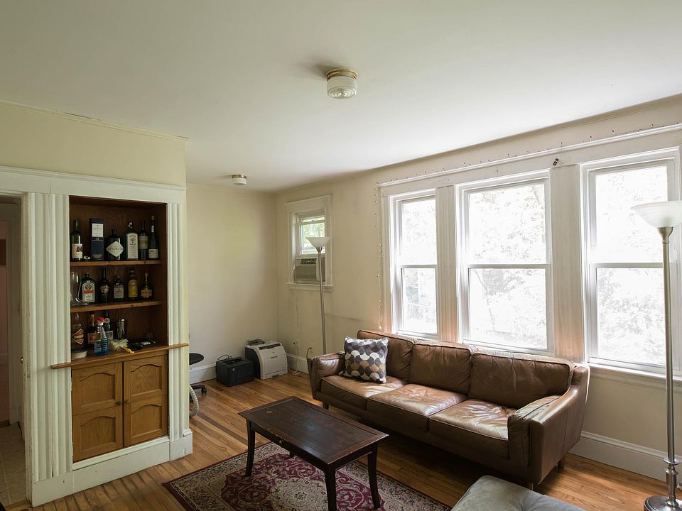 Large living room with original built-in and bonus alcove.