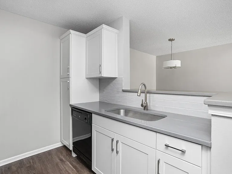 Updated kitchen with white cabinets and quartz countertops