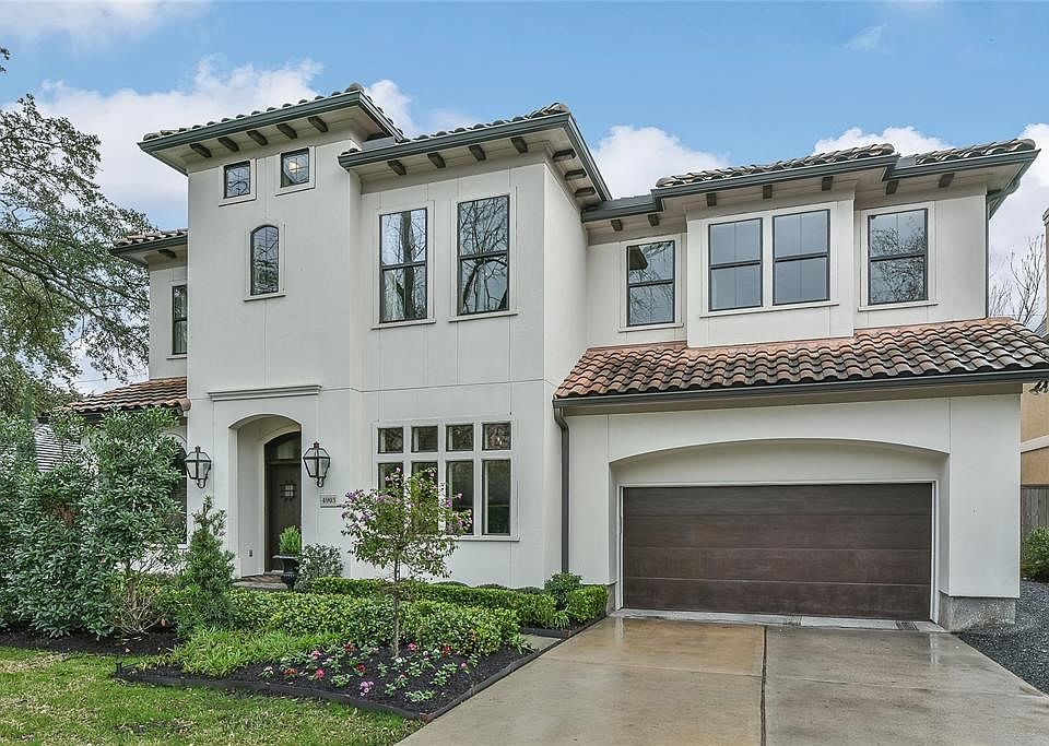 Absolutely stunning Mediterranean style stucco home with tile roof and beautifully landscaped yard.