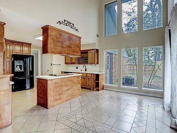 The dining area is located off the kitchen with a wall of windows that view the back yard and brings the light in.