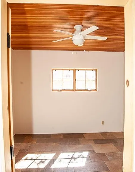 Large sunny second bedroom with high wood ceilings, huge closet and fan. Large full bath is just off this.