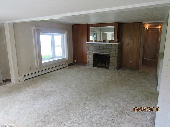Enjoy ambiance and warmth by the fireplace with a little view of the lake.