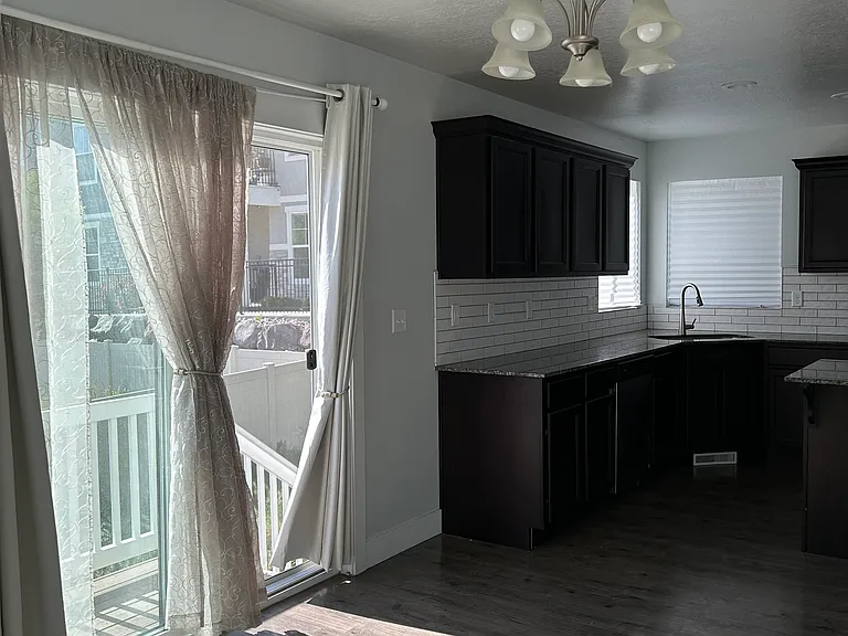 Kitchen with sliding door to small deck. Currently working on yard due to lack of maintenance from previous tenants