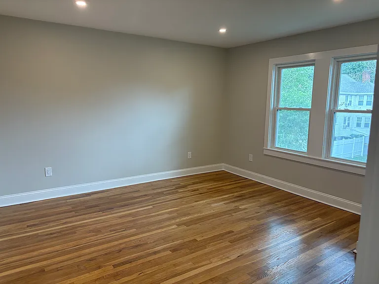 Bedroom #1- New windows, refinished hardwood floors, new electrical, new doors, new sheetrock, and new insulation.