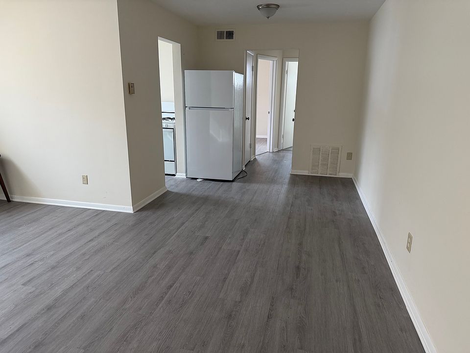 Living room view from front door showing Kitchen on left side and hallway to bedroom and bathroom