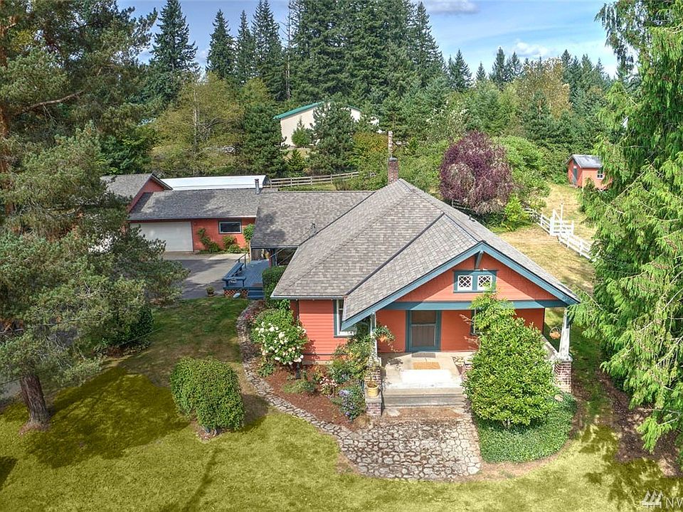 Welcome Home to Lake Youngs! Charming 1923 Craftsman situated on 1.44 acres, this 4 bedroom, 2 bath home is the quintessential gentleman's farm.Gated entry. Fenced and cross fenced-bring your livestock!  You will fall in love with the time-honored 1923 craftsmanship of this rare home, along with multiple out buildings, a fenced pasture, covered RV parking and so much more. Upon entering the living room, the beautiful cov'd 9' ceilings, traditional hardwood floors and historic wide trims and casings will transport you back to a time when homes were crafted instead of built. Dual window seats flank the welcoming living room which is bathed in old world charm. The gorgeous built-in bookcases with lead glass windows and classic craftsman pillars provide a perceived sense of separation to this large impressive room. The previous owner went to great lengths and expense when updating the windows with custom wood clad, leaded glass windows made to replicate the antique craftsman style.