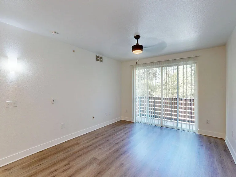 Apartment living room with wood style floor.