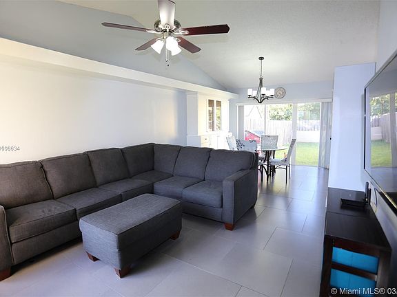 Living room towards dining room and rear sliding glass doors.