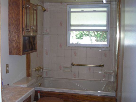 Main bath with new tile floor and counter