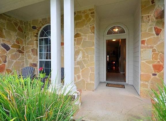 closer up of front porch with great yard landscaping