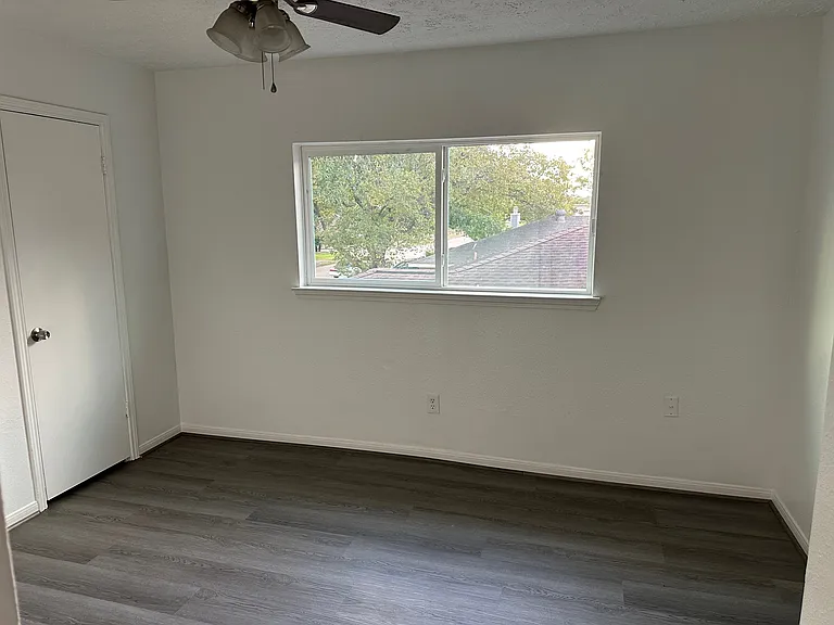 2nd bedroom with fan and closet