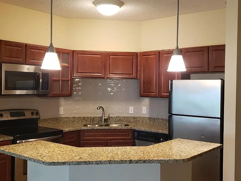 Kitchen closeup of the beautiful new granite counters, cherrywood cabinets and stianless steel appliances.