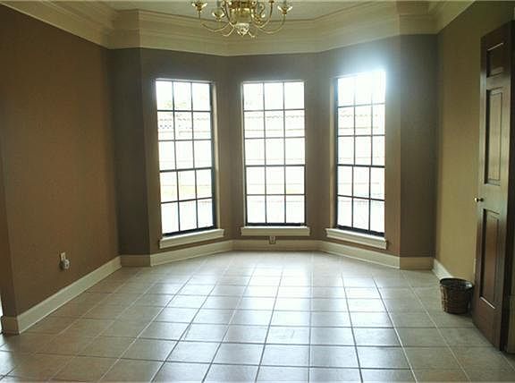  Lots of light pours in to this formal dining room, complete with lovely tile floors.