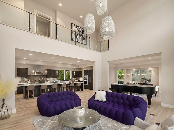 Dramatic two story great room flows into dining room + chef's kitchen
