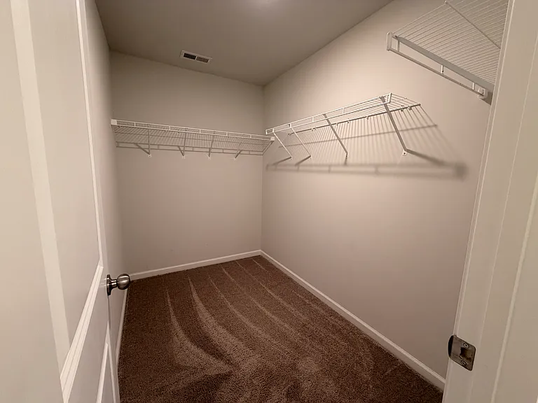 Walk-in closet in primary bedroom