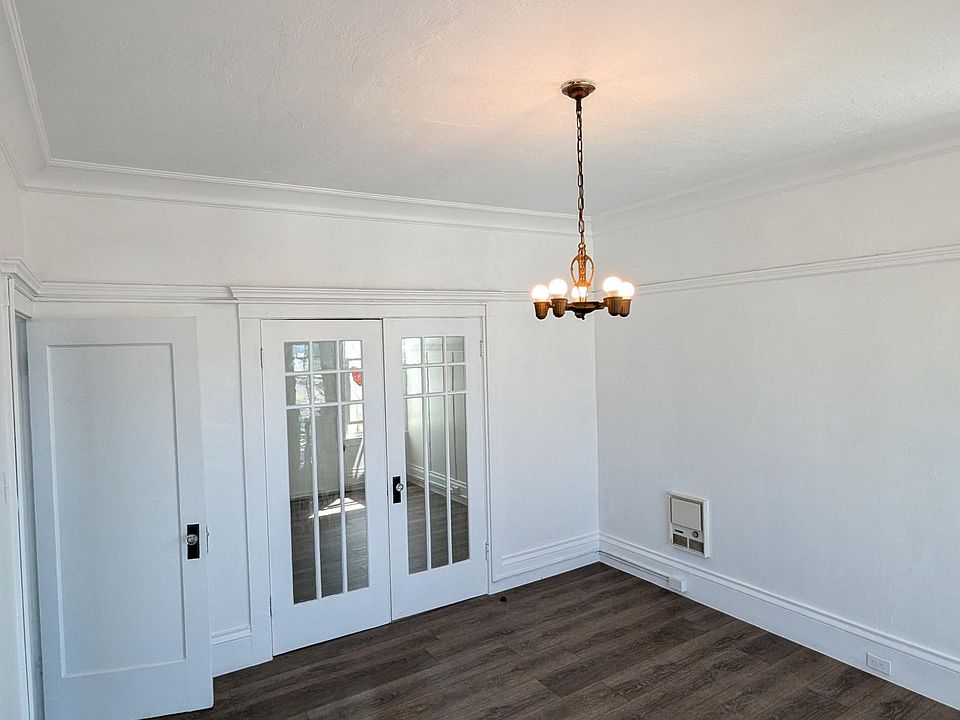 This a view of the large living room / second bedroom with high ceilings