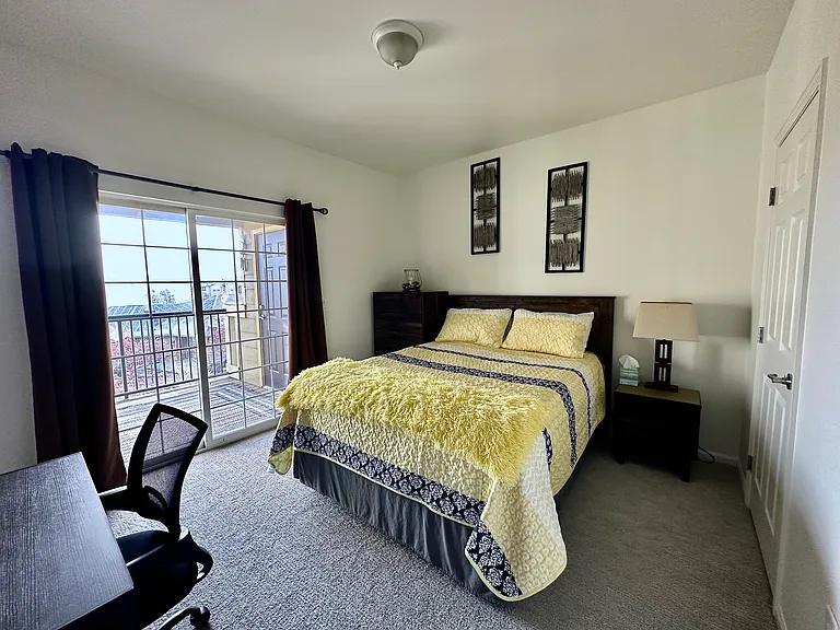 Queen bed, desk and chair. Walk-in closet. Balcony with patio furniture.