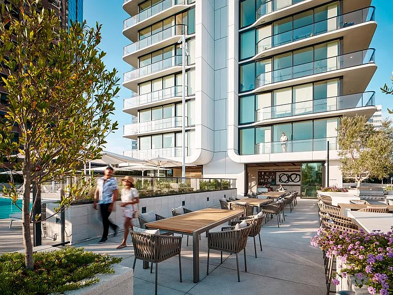 Outdoor lounge with barbeques lead to pool area and 2nd floor clubhouse