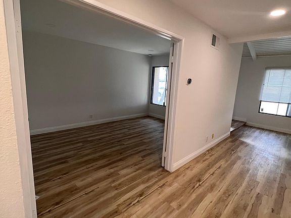 Living room with attached Den with closing door used for office or Gym or formal dining room .