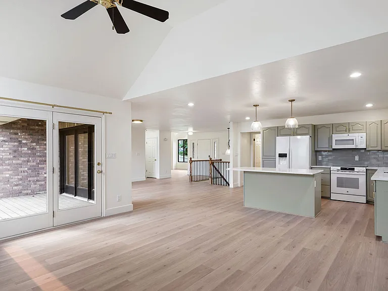 Stunning great room with vaulted ceilings and doors opening to the view.