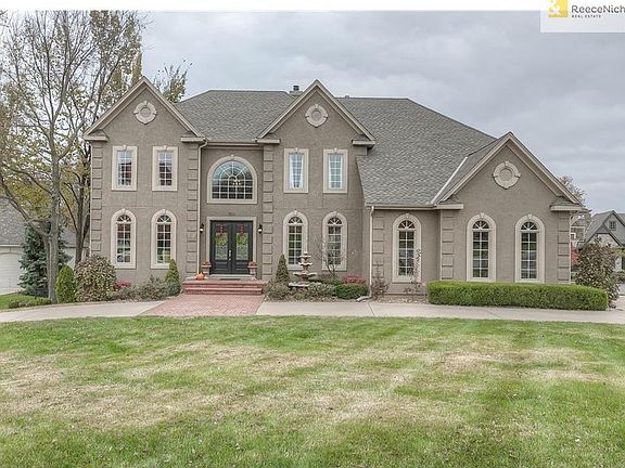 Wonderful curb-appeal with brick porch, circle drive, and side-entry garage