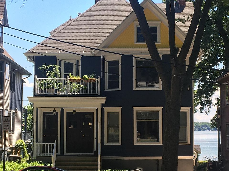 Street side shows upper private balcony and front door on left.