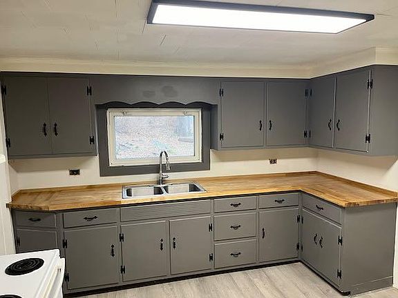 Kitchen, counter, sink, and cabinets view