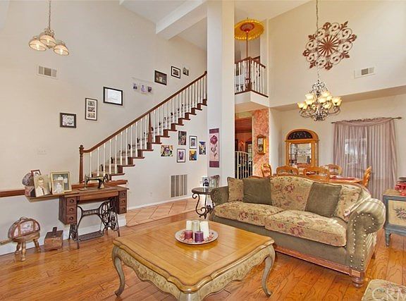 Formal living room with volume ceilings and wood flooring,