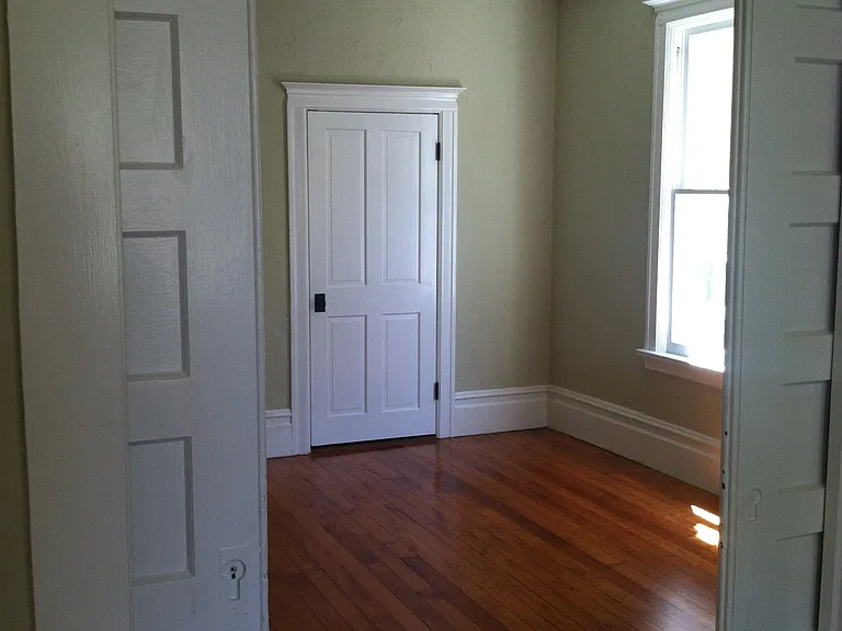 First bedroom with sliding door from Living Room.