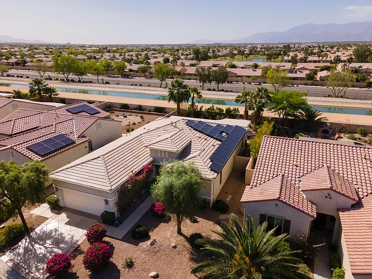 Southerly bird's eye view from front of property. Notice the monthly expense saving (Photovoltaic) "solar" panels for producing your own electricity!