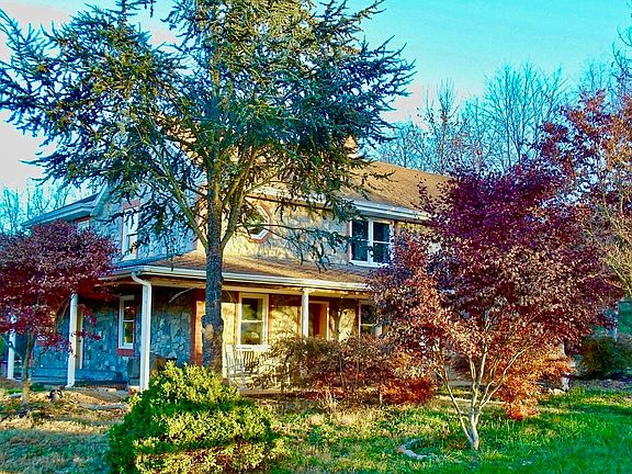 Comfortable front and side porch with rocking chairs
