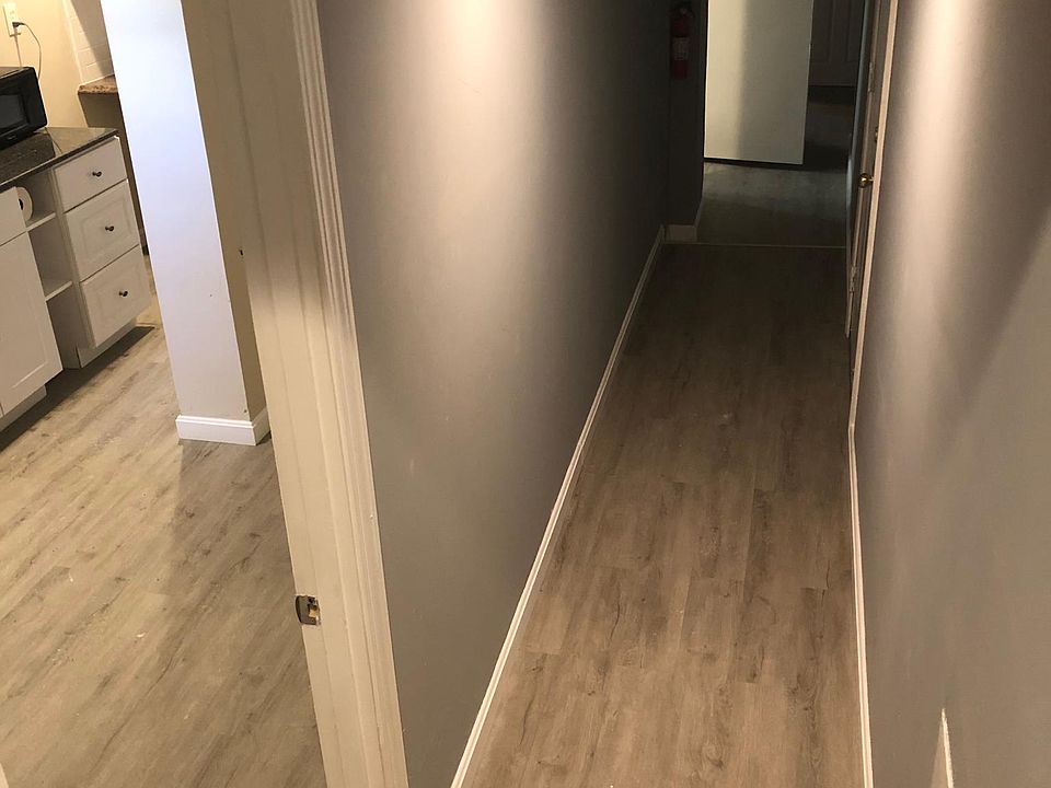 Comm hallway, kitchen to left, bathroom in middle, bedroom in back.