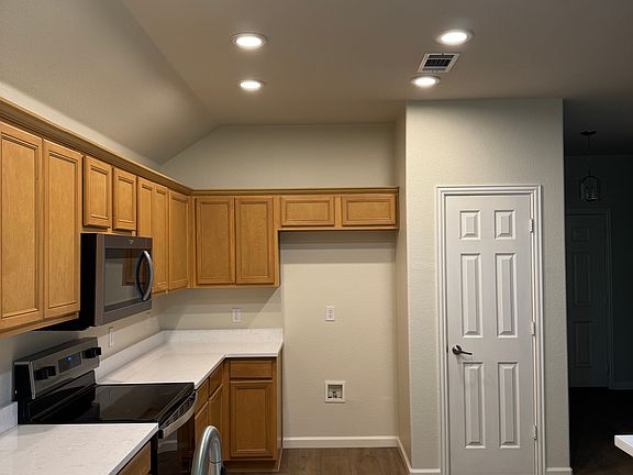 Kitchen with new quartz countertops, new stainless appliances, new sink, new disposal, new faucet, new canned lighting, freshly painted, and new LVP flooring