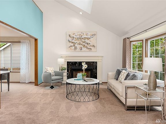 Formal living room with wood-burning fireplace.