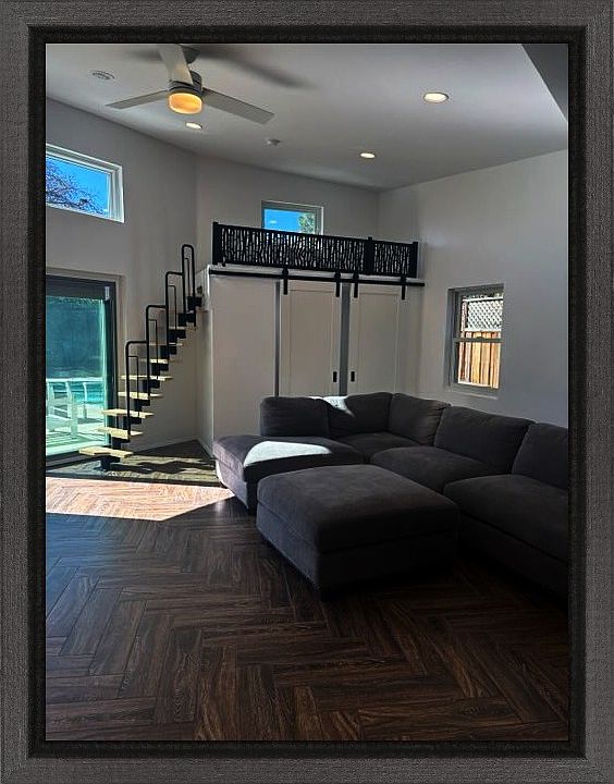 looking from the kitchen to the living room the small room, the loft, and the pool