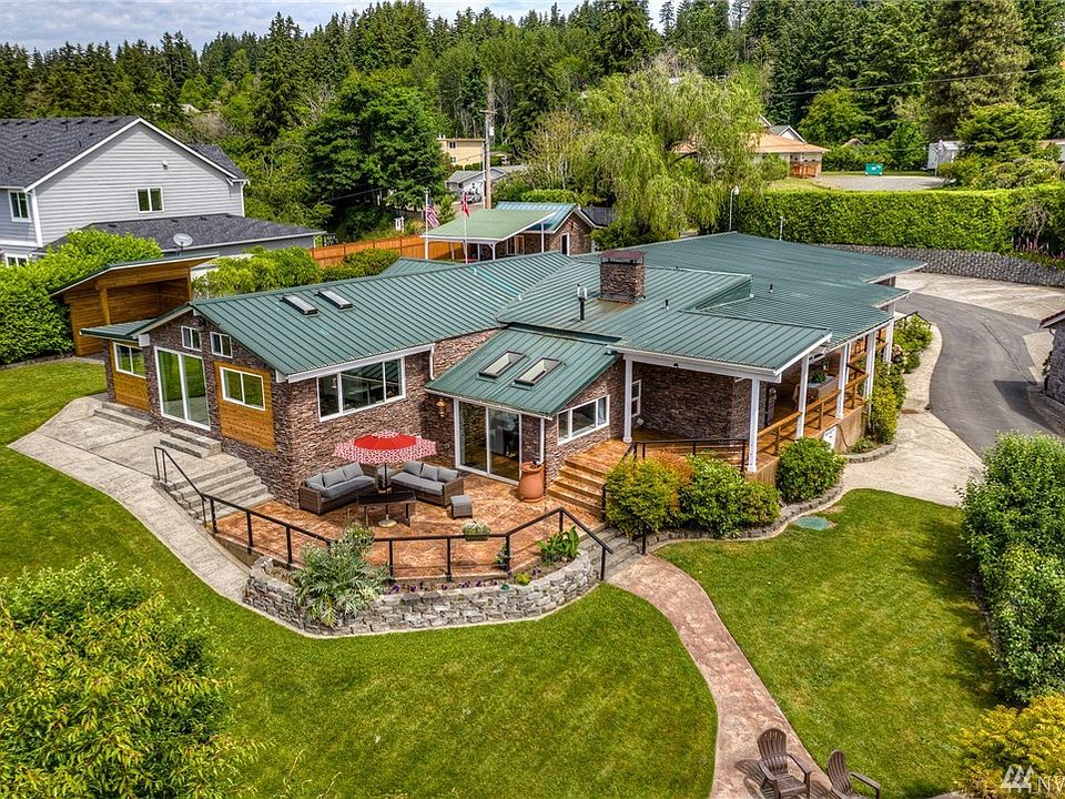 An overall view of the house, covered patio area (perfect for bbq'n in the rain) and carport/shop
