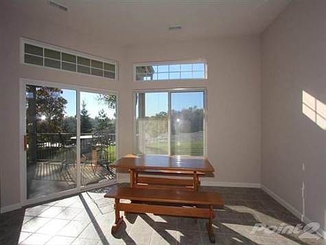 Breakfast room with transoms and walkout to covered balcony.