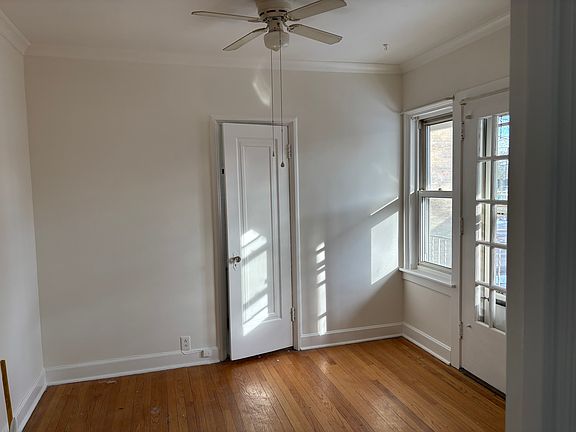 Living Room with access to balcony. Ceiling fan has been changed.