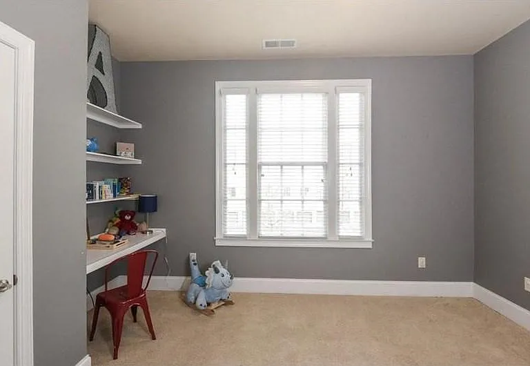 Bedroom looks over the parking spaces in the back