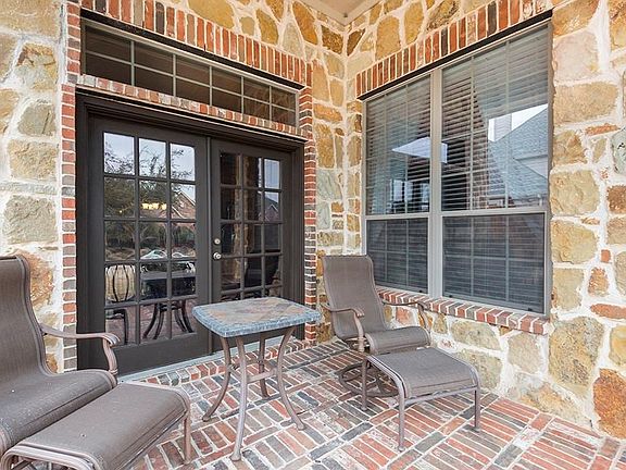 French doors lead from the formal living room to the covered front porch.