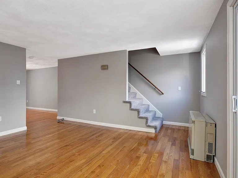 Spacious living room with real hardwood floors.